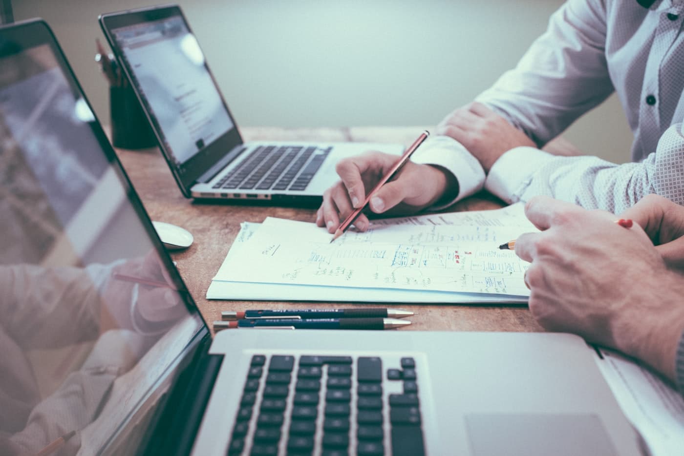 An advisor and client reviewing notes and figures together at a desk